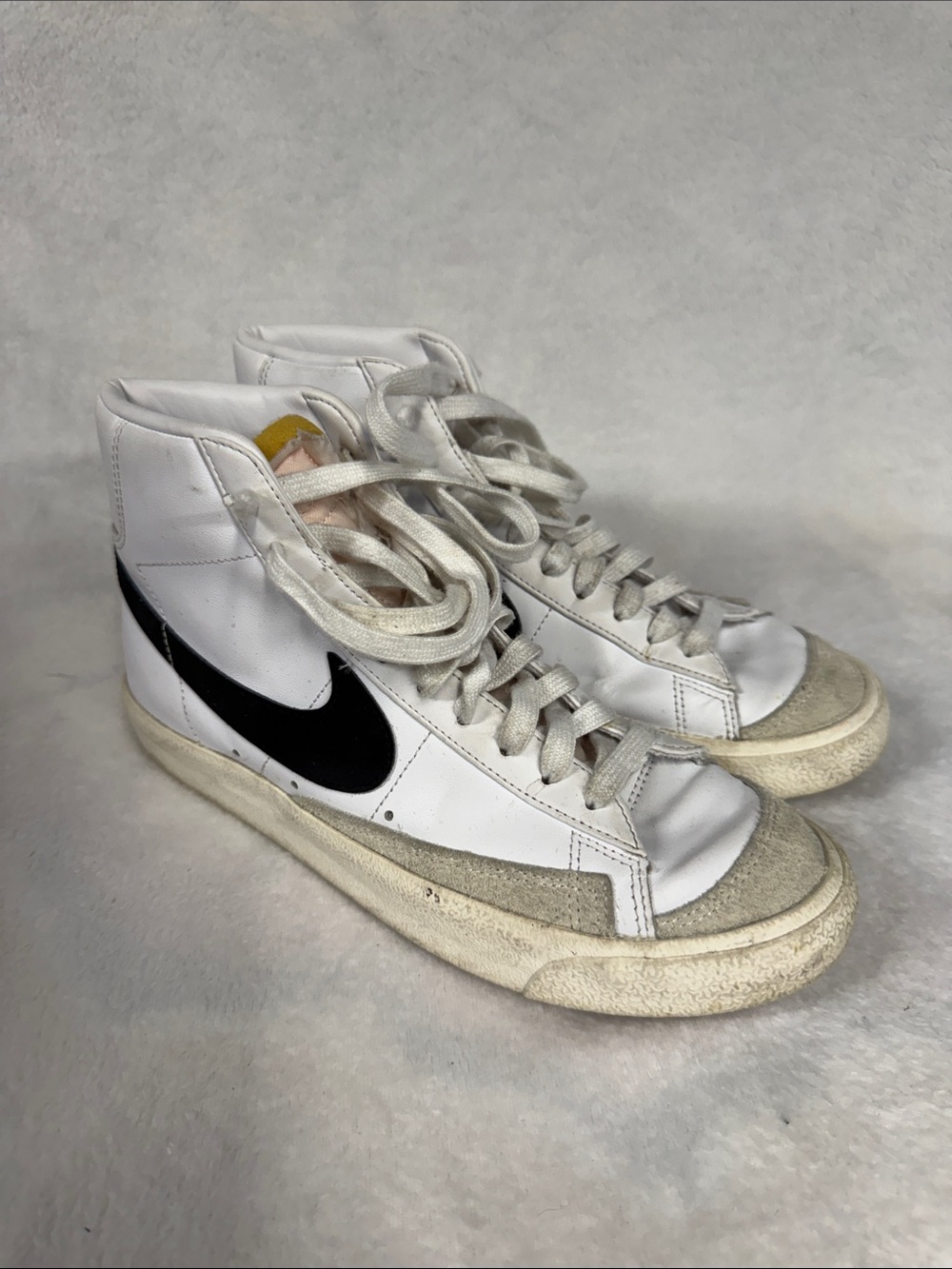 Nike Womenโs White High-Top Sneakers with Black Swoosh